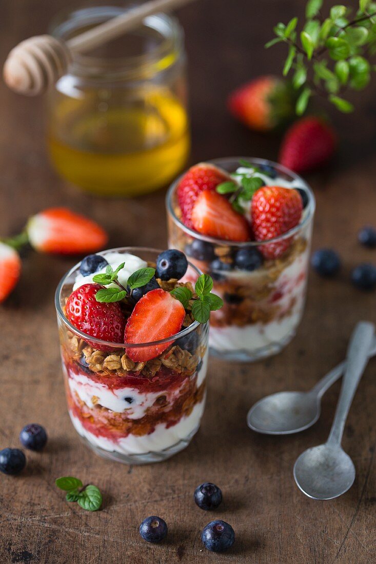 Granola with yoghurt parfait, strawberries and blueberries