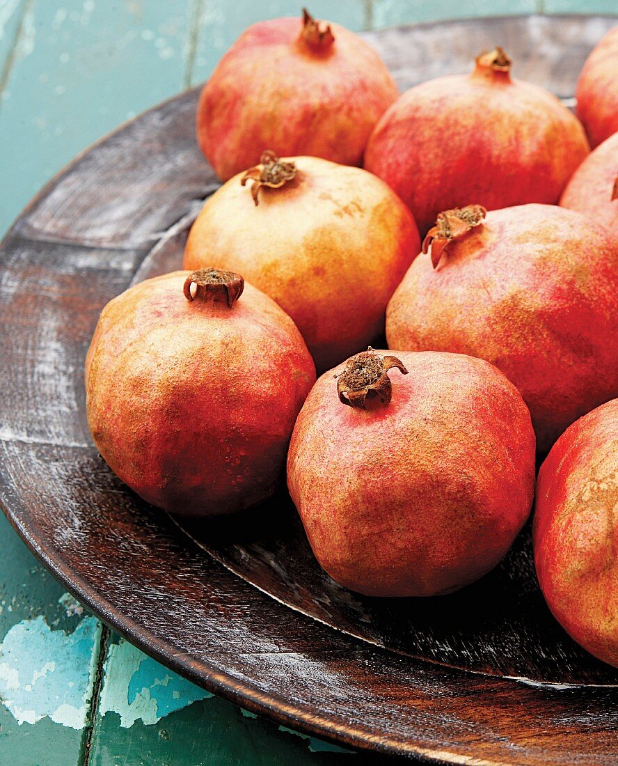 Several pomegranates on a plate