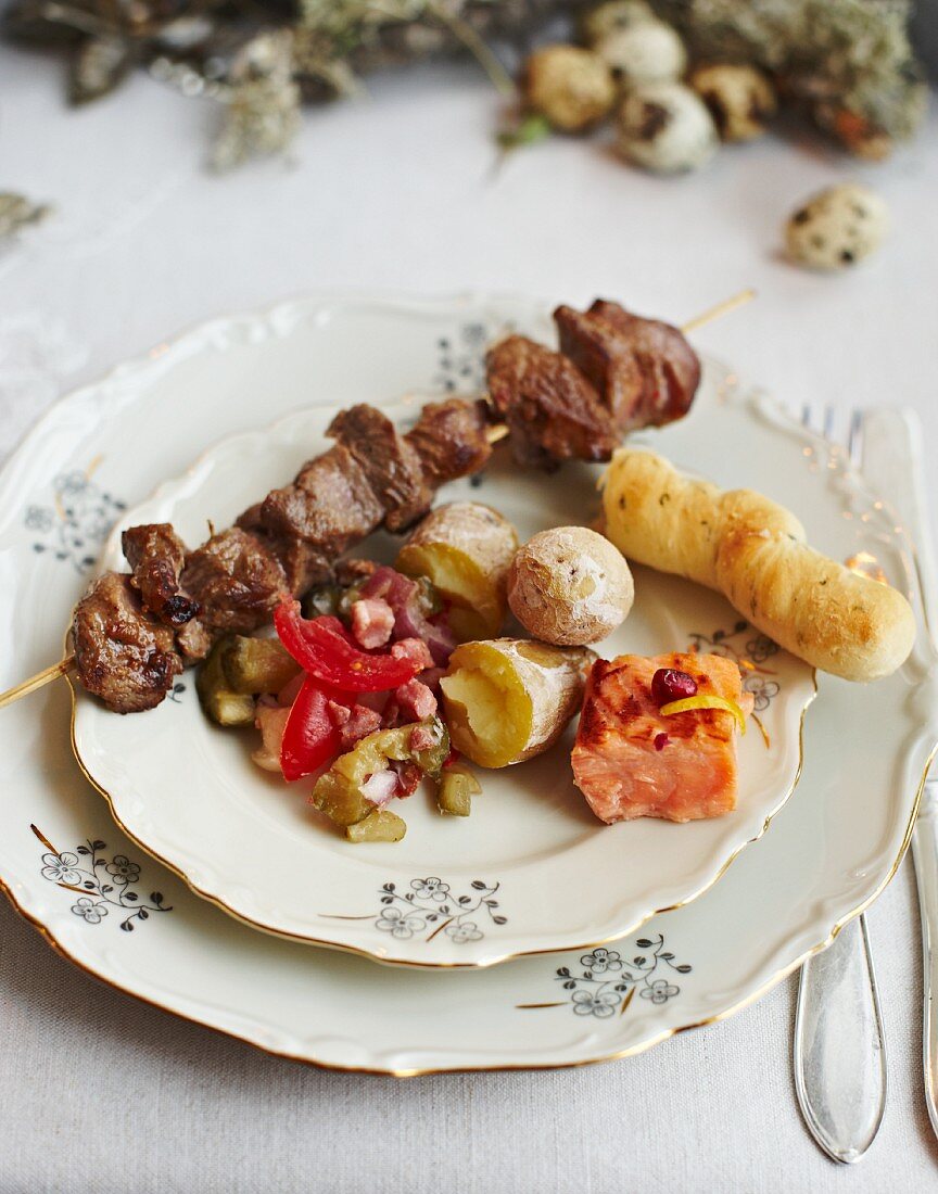 Lamb skewers with salt potatoes, pickles, salmon, and dill bread