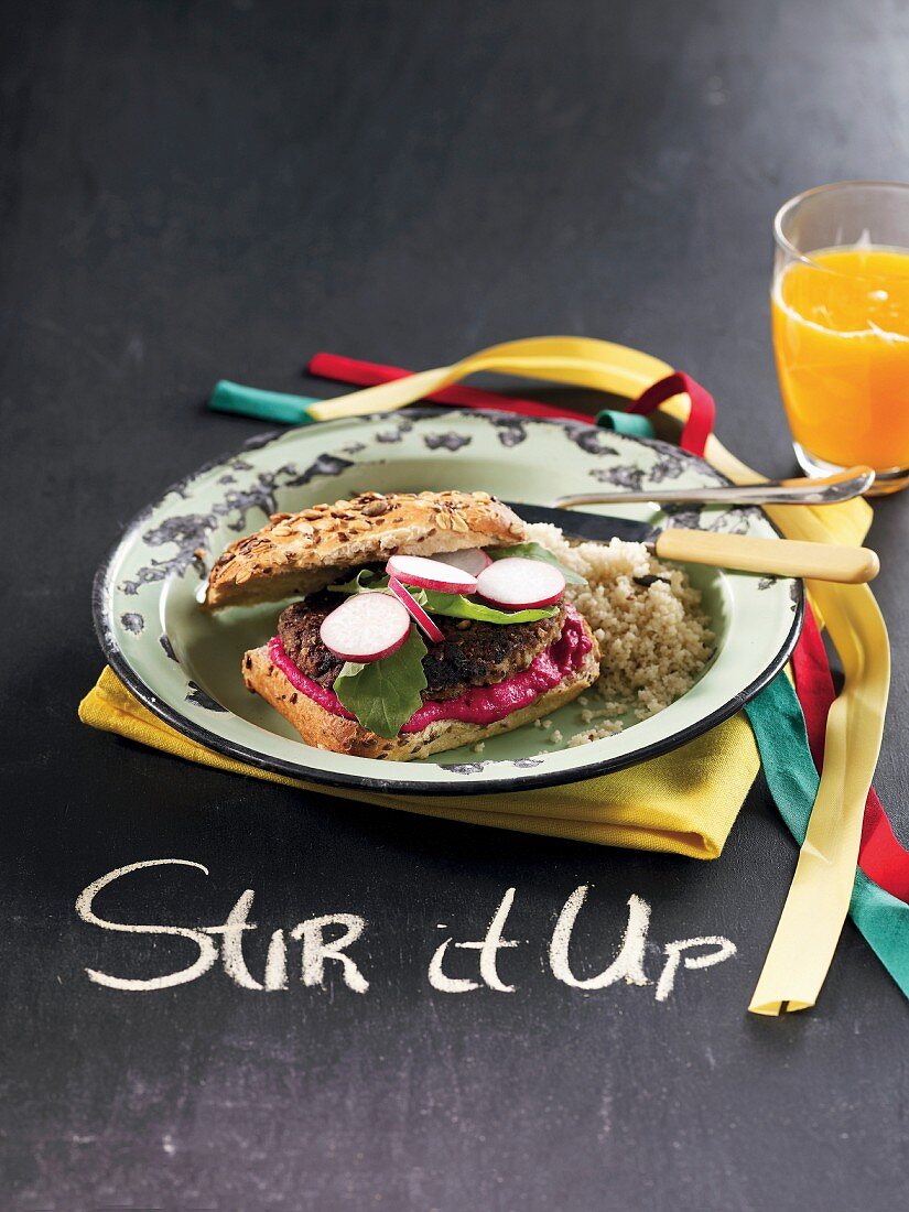 A lentil and tofu burger with beetroot hummus and couscous