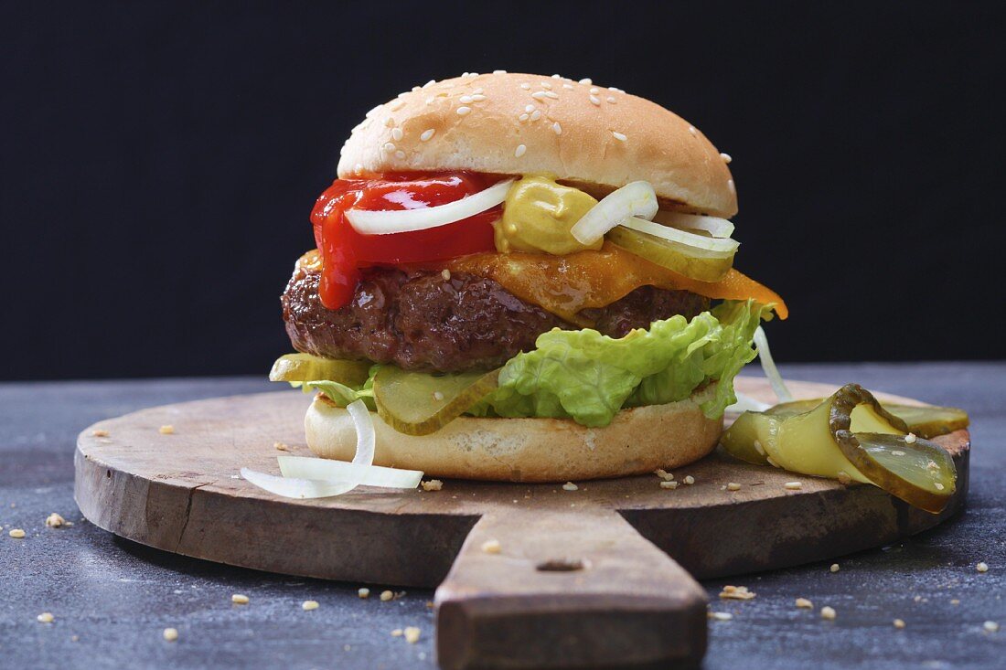 A hamburger on a wooden board