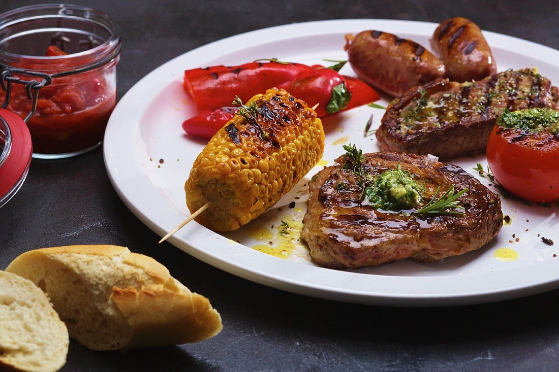 A plate of grilled meat, sausages and vegetables