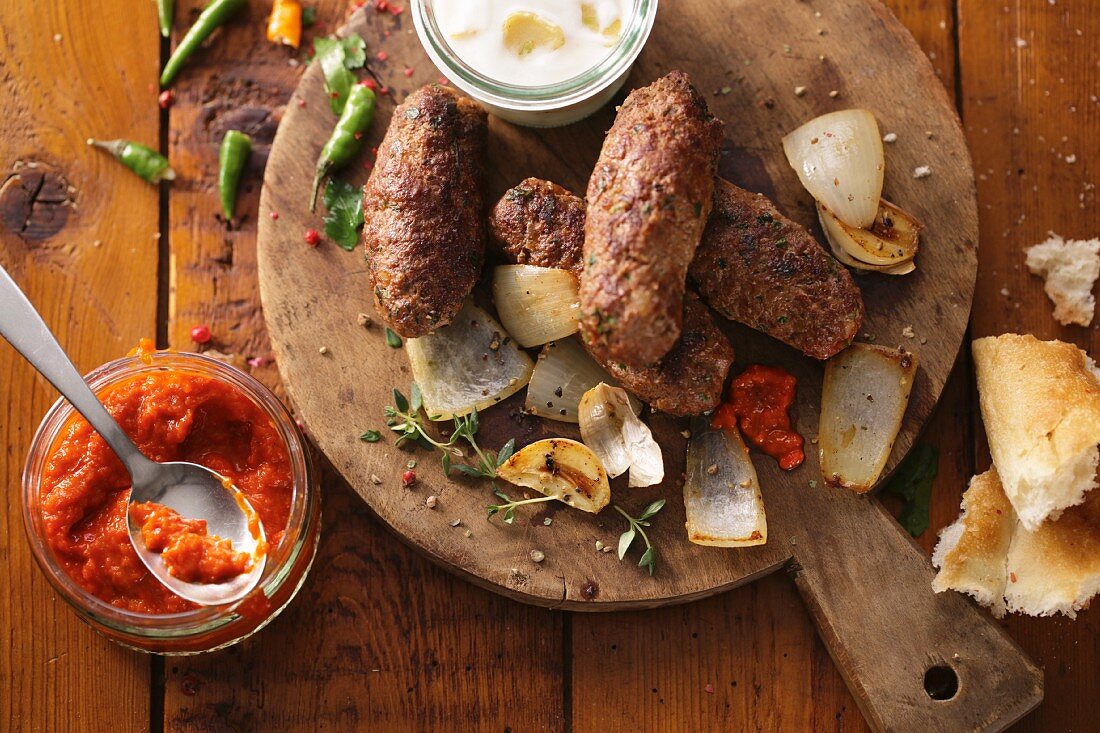 Cevapcici with ajvar (grilled minced meat sausages, Balkans)