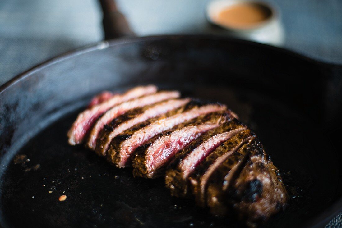 Rare rumpsteak marinated with chilli and cumin in a pan