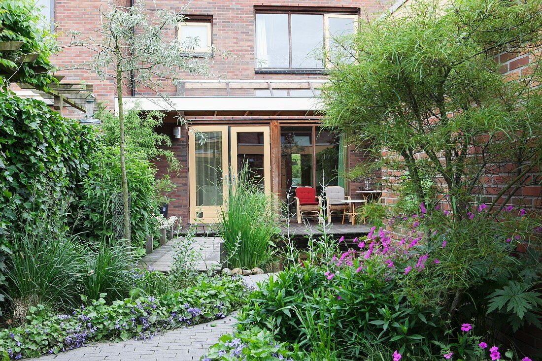 Brick house with front garden, terrace and pond