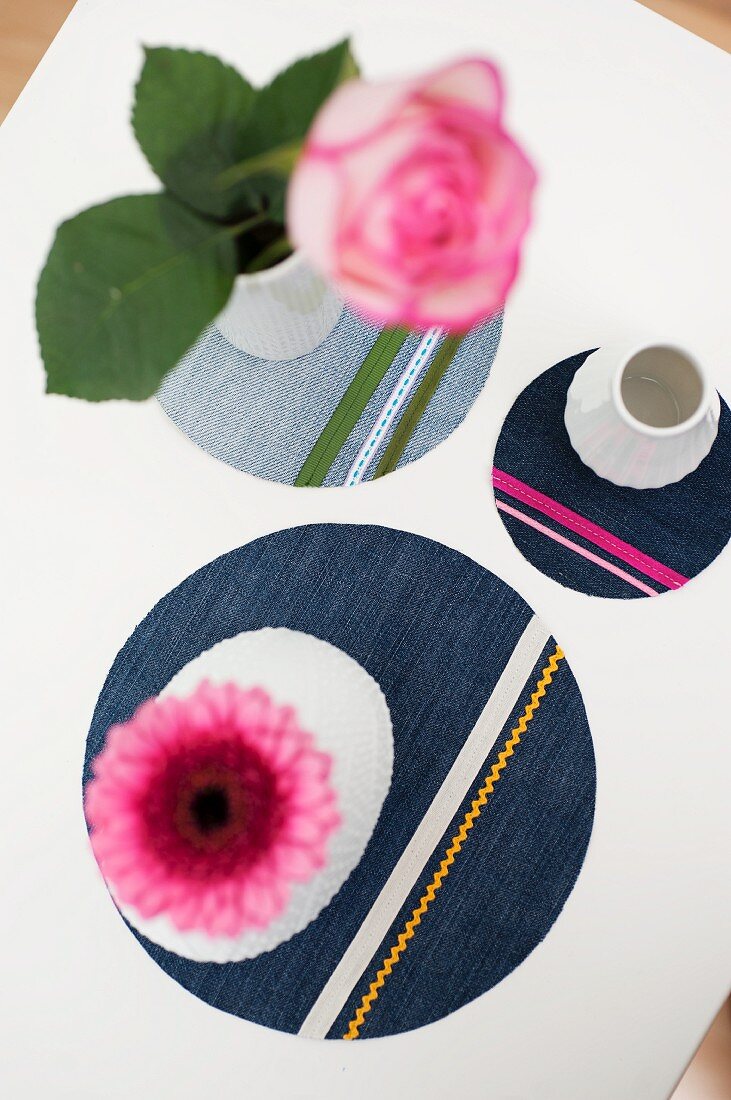 Round denim coasters decorated with colourful trims and ribbons