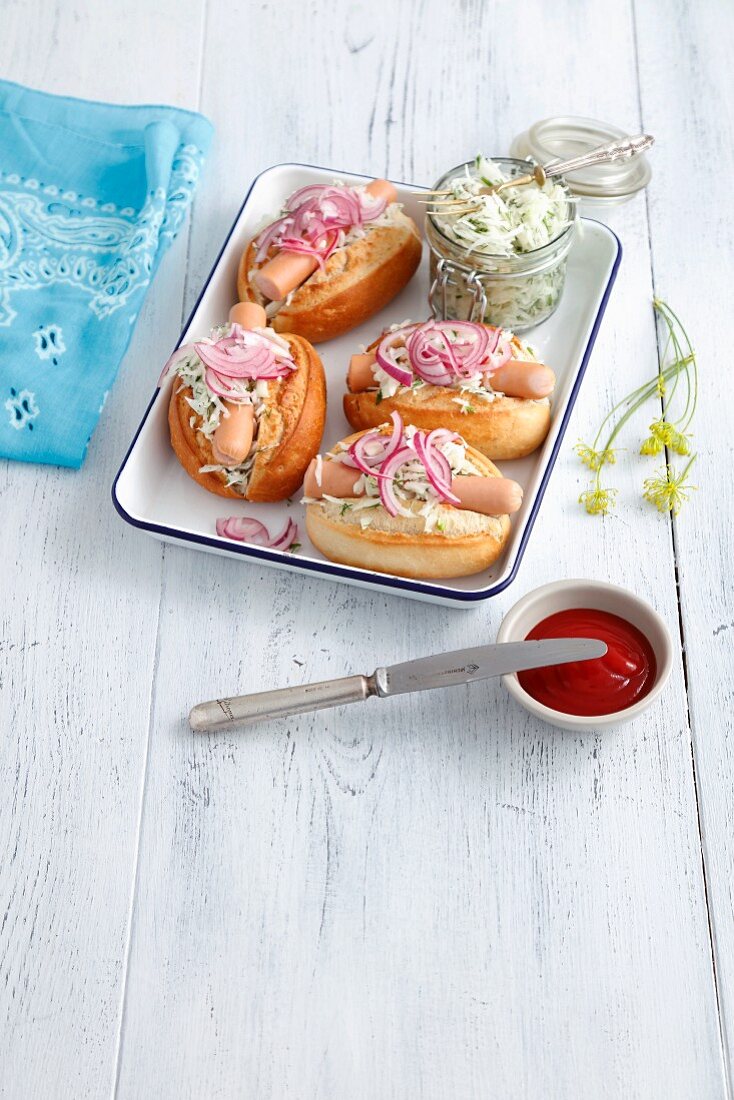 Hot dogs with coleslaw and pickled red onions
