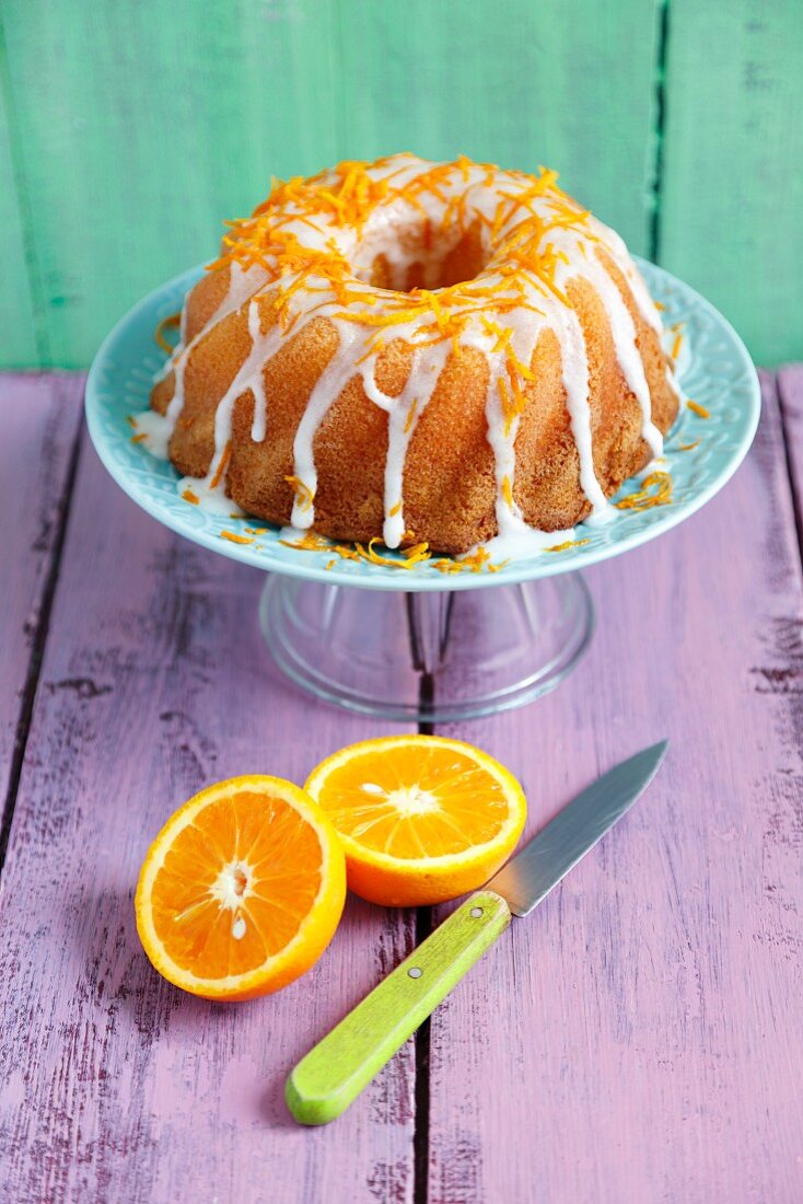 Orange cake with white icing and orange zest