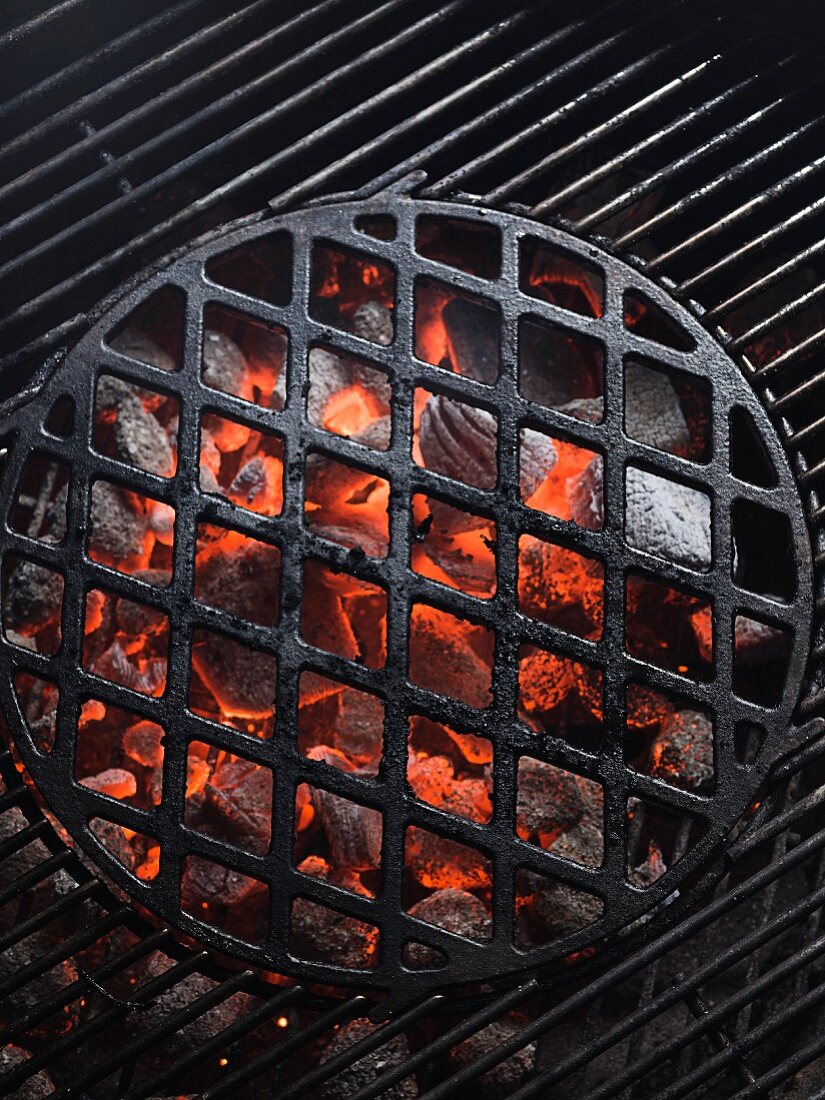 Glowing charcoal and a cooking grid