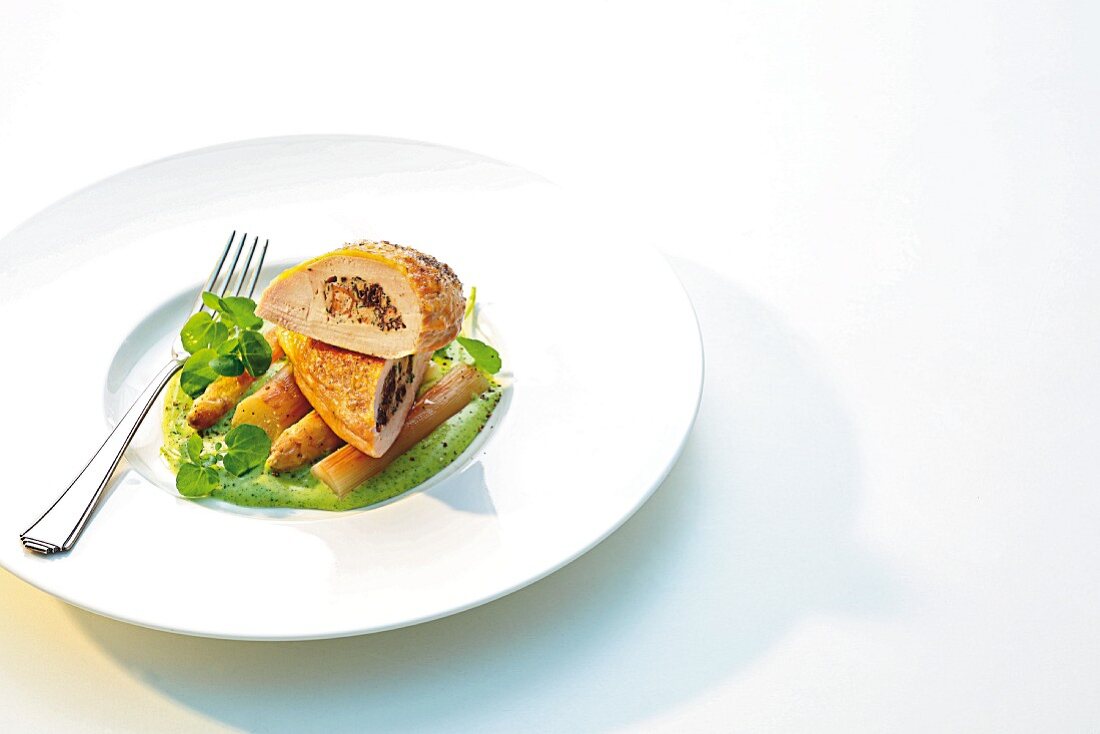 Corn-fed chicken breast filled with morel mushrooms on fried asparagus and watercress foam