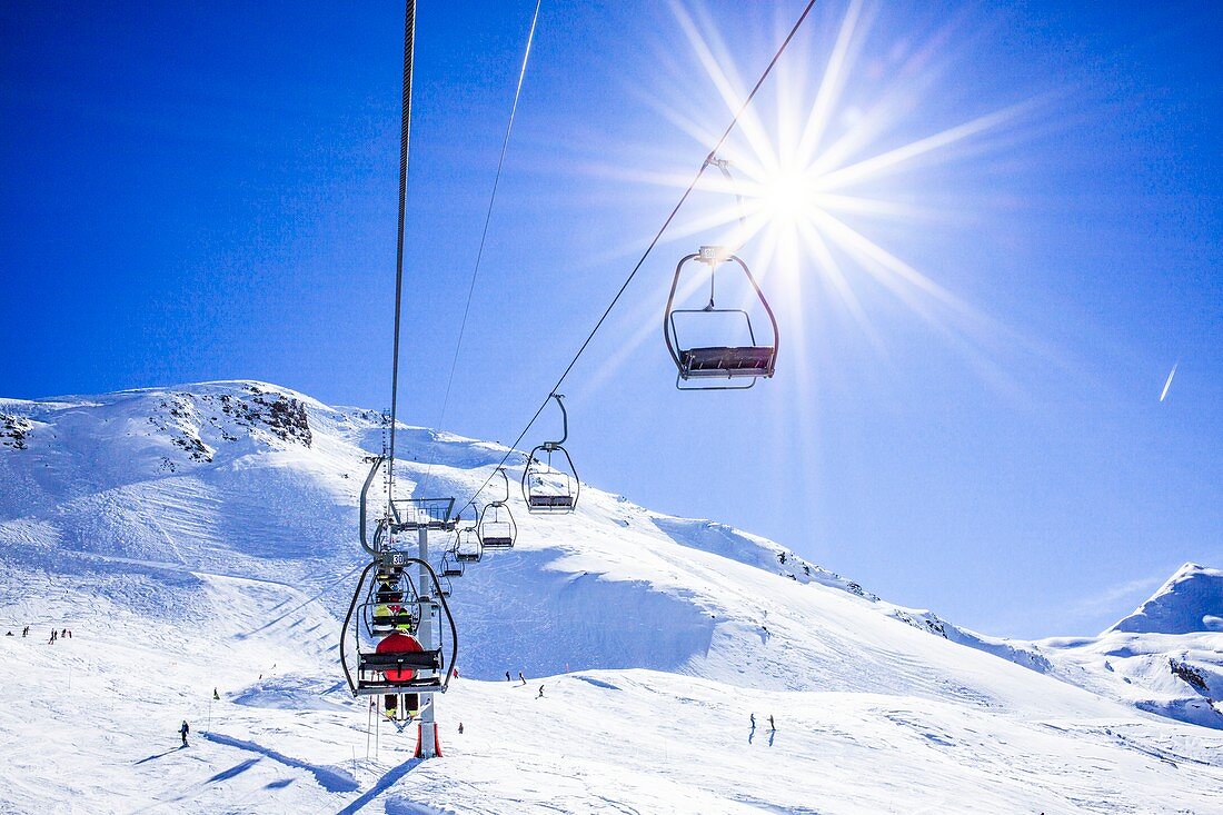 Skiers ascending on a ski lift