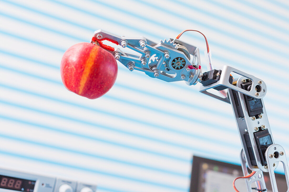 Robotic arm holding apple