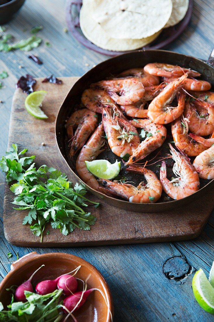 Pan Fried Shrimp in Skillet; Peels and a Glass of Beer