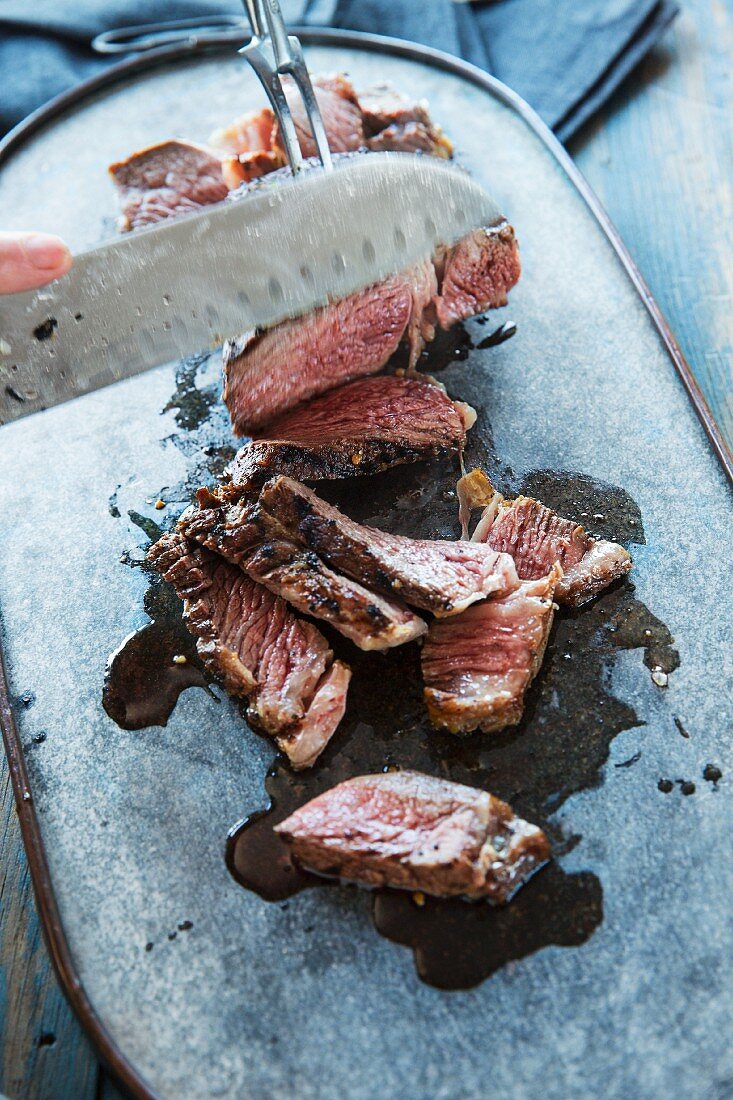 Grilled Mexican steak being sliced