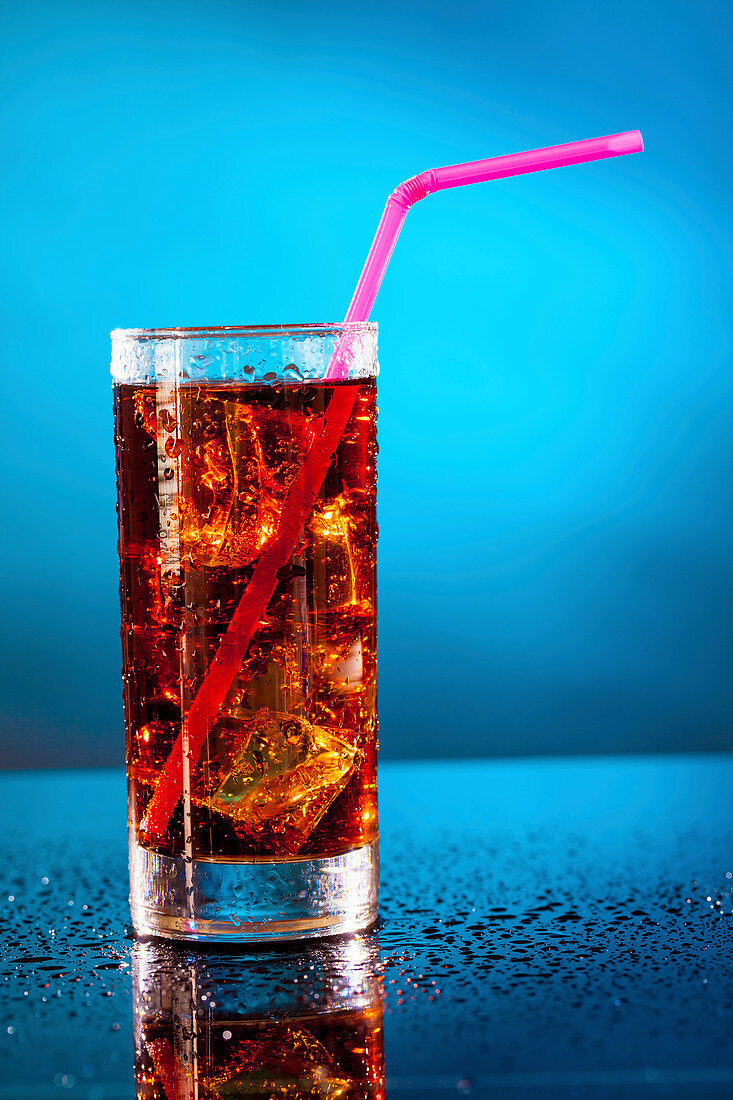 Glass of soda with a drinking straw