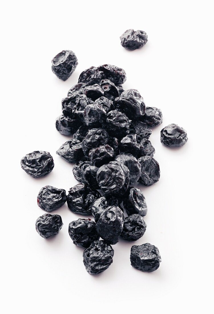 Dried blueberries on a white surface