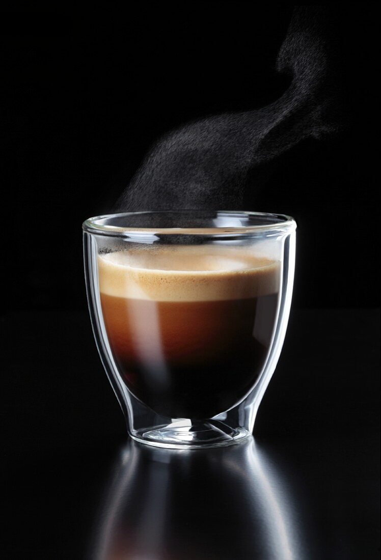 A glass of steaming espresso