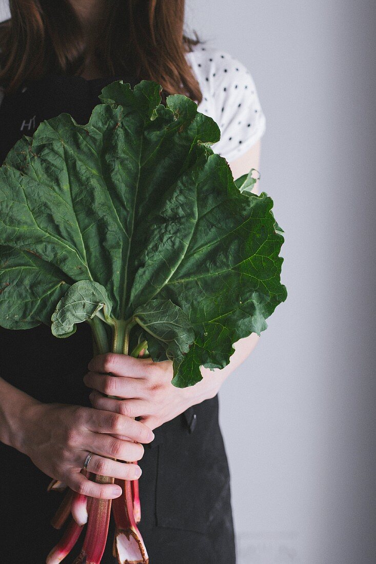 A woman holding rhubarb