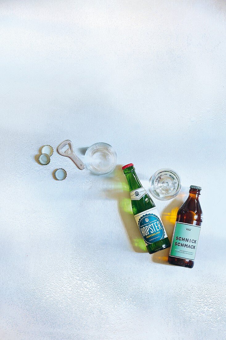 Hops lemonade and white grape spritzer in bottles and glasses