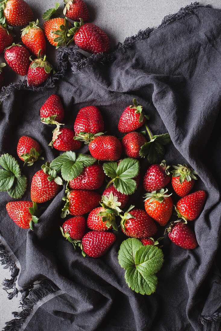 Fresh strawberries on a grey cloth