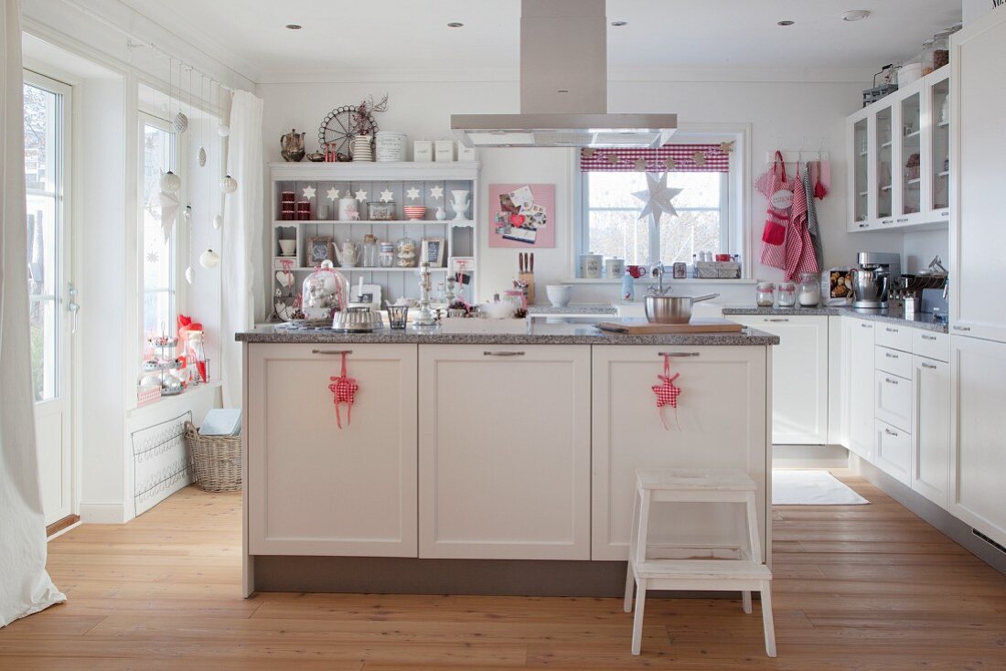 Festively decorated white country-house kitchen