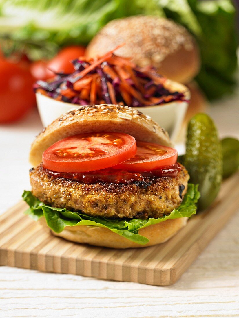 A veggie burger with chilli sauce, tomatoes and lettuce