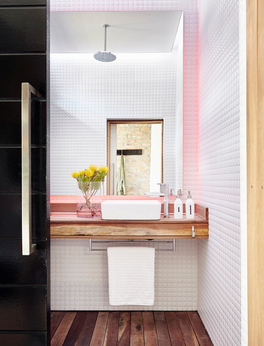 Small bathroom with mosaic tiles and wooden floor