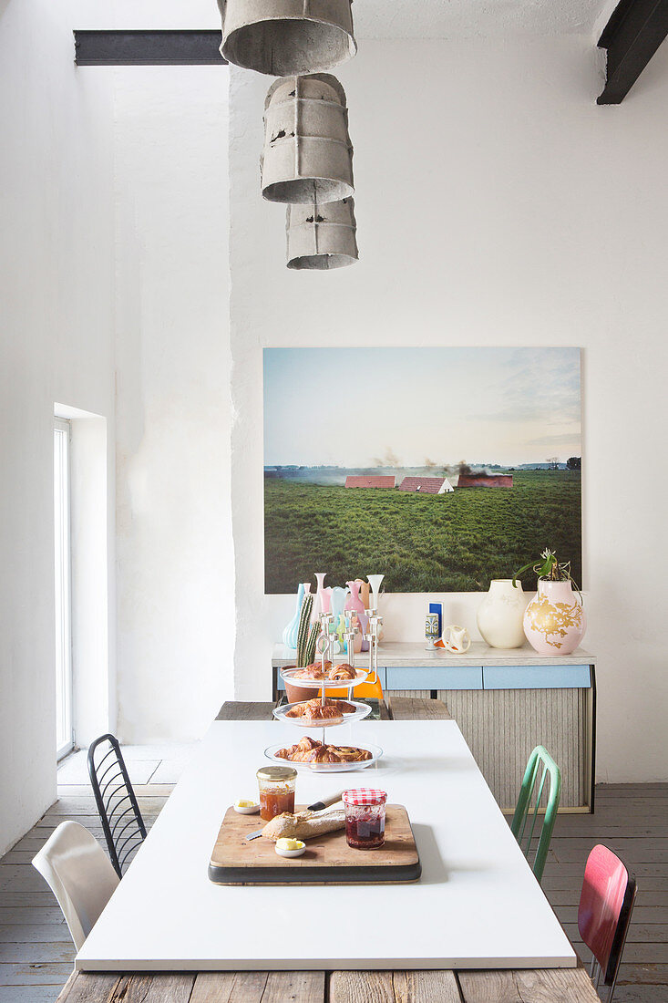 Rustic dining table with white top panel in open-plan eclectic kitchen