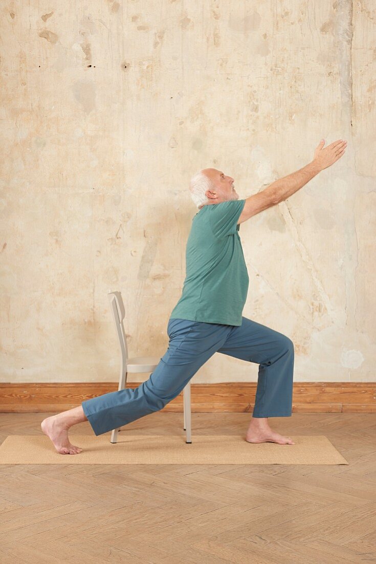 Warrior (yoga) standing: leg back, stretch arms up