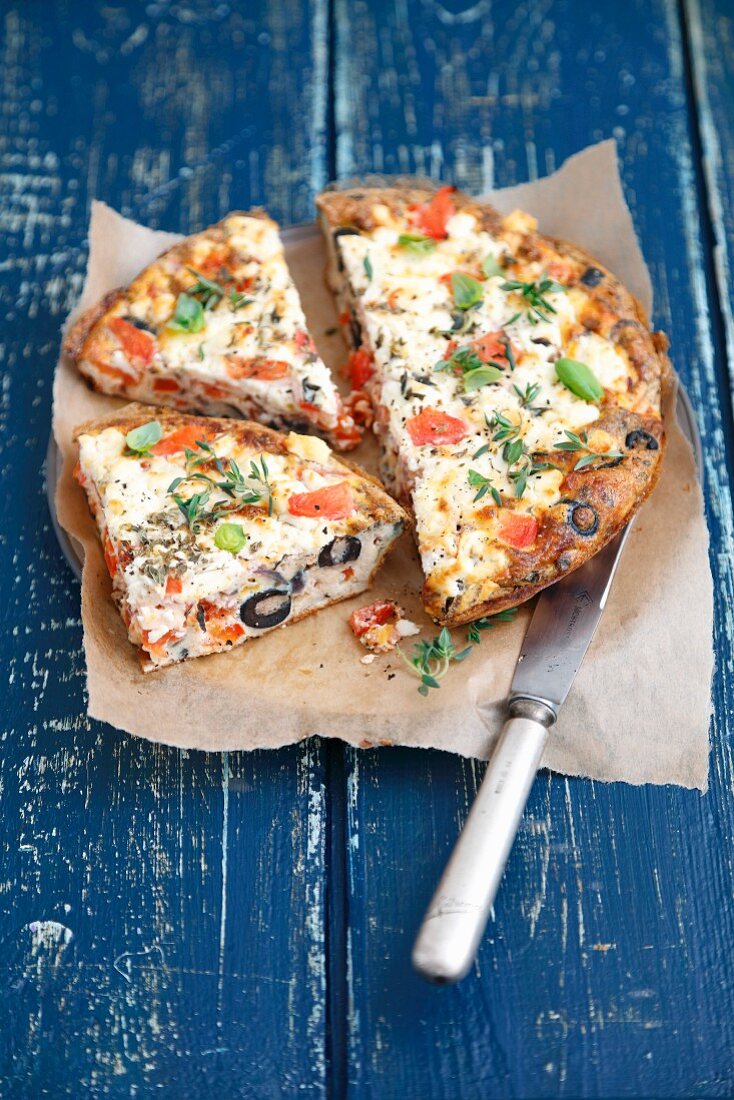 Oven-baked frittata with tomatoes, feta cheese, olives and peppers