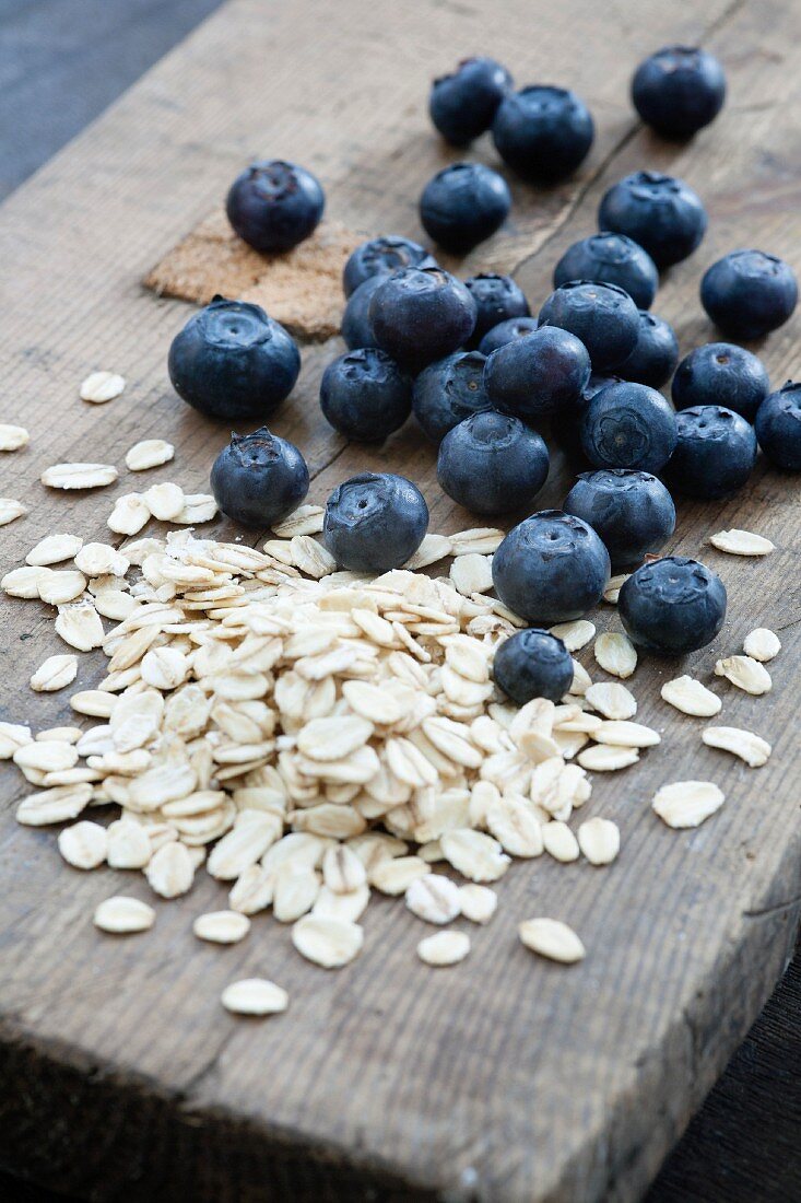 Blueberries and oats on a wooden board