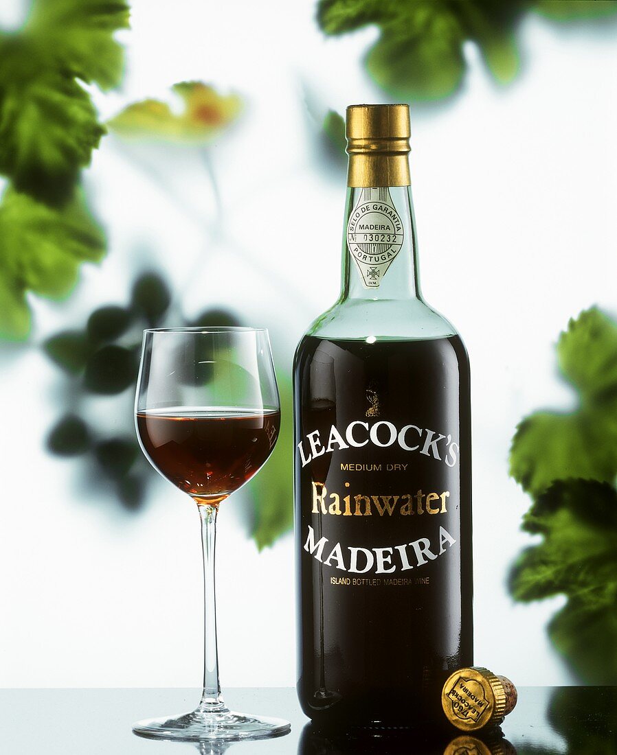 A bottle of Madeira and a half-filled glass