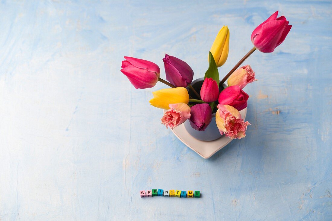 Spring arrangement of tulips and 'Springtime' written in small letter blocks