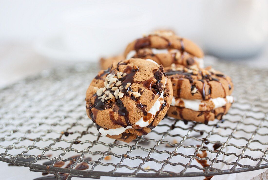 Chocolate biscuit with hazelnuts filled with quark on a wire rack