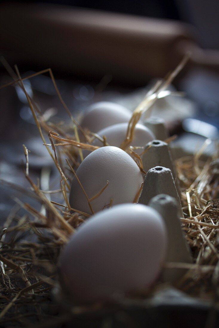 Eggs in an egg box lined with straw