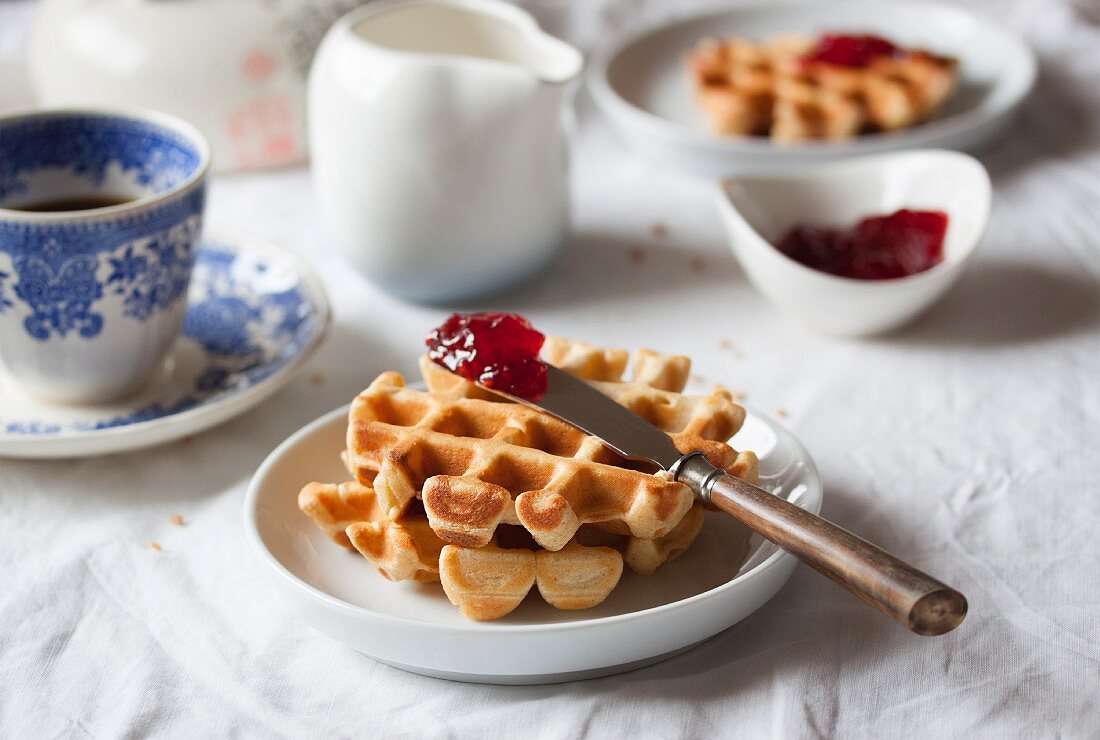 Cornflour and spelt waffles with raspberry jam served with coffee