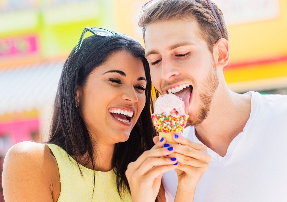 A couple sharing an ice cream cone