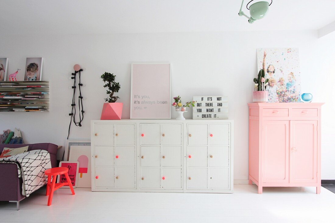 Pink and white furniture in open-plan interior