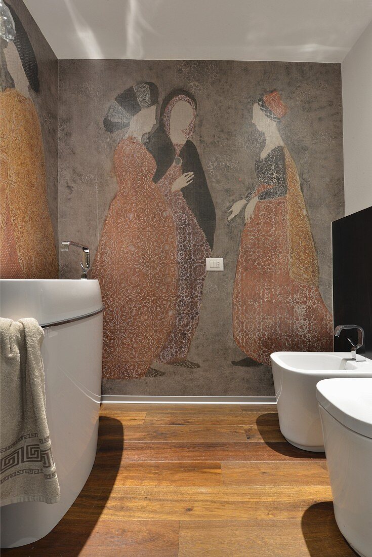 White bathroom suite in modern bathroom with antique-style mural of women