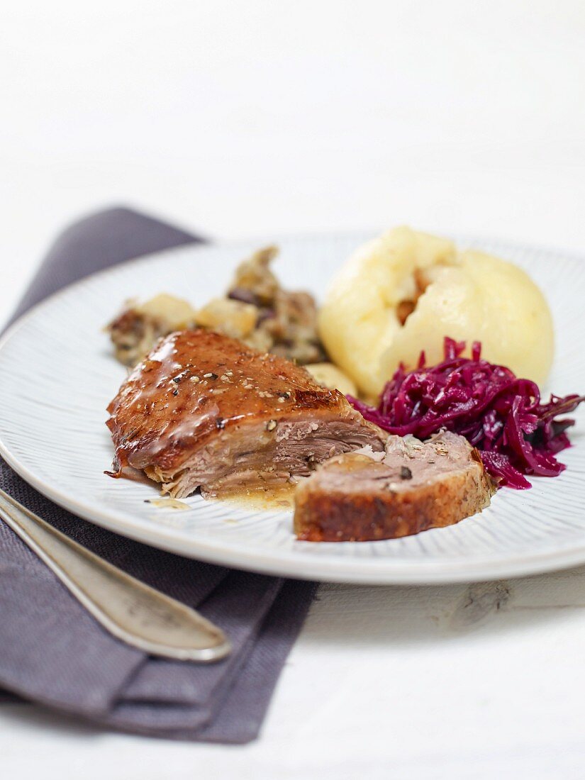 Goose with a chestnut stuffing served with red cabbage and dumplings