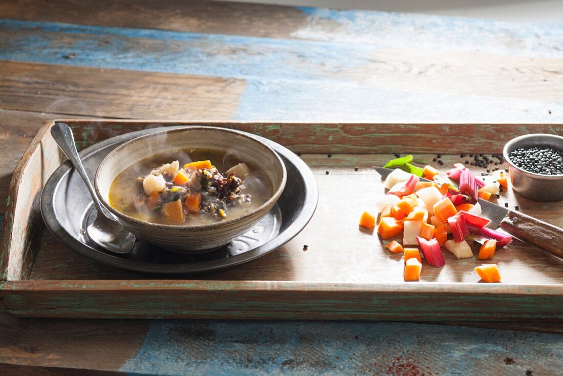 Steaming lentil soup on a wooden tray