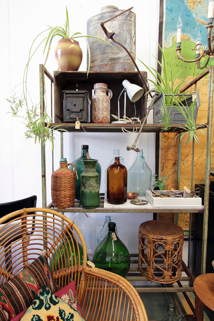 Collection of bottles and other flea-market finds on vintage metal shelving