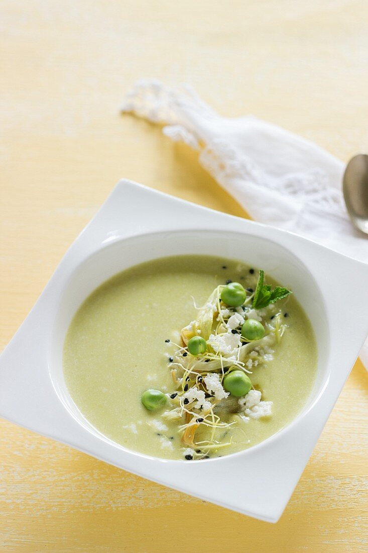 Cream of pea soup with feta cheese and bean sprouts