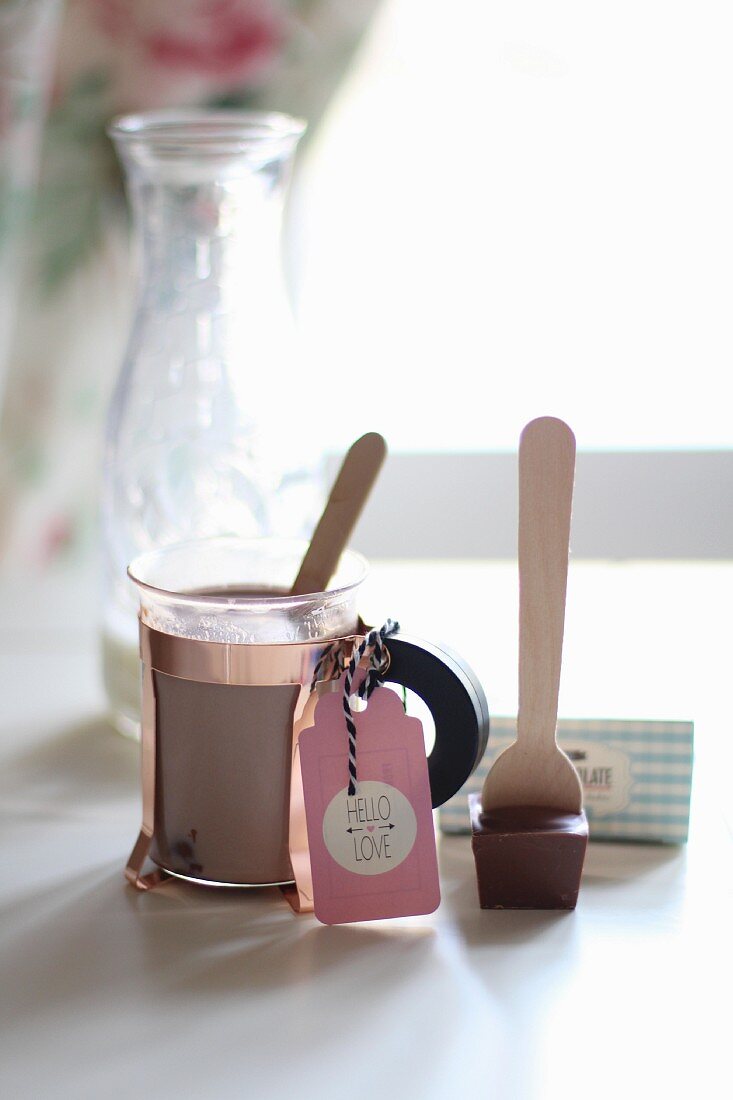 A glass of cocoa made from chocolate spoon