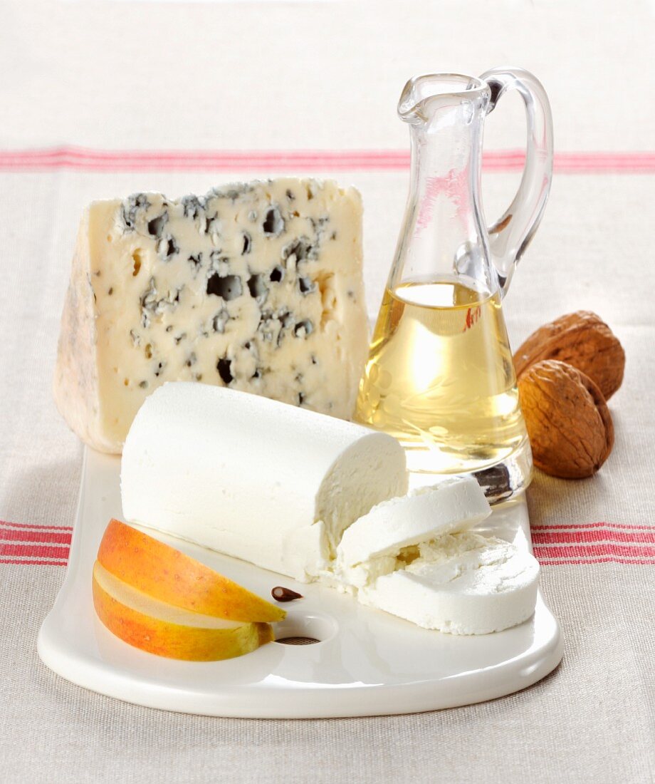 A cheese platter with Roquefort and a roll of goat's cheese