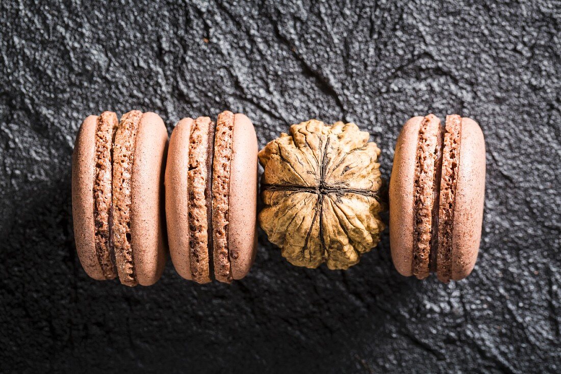 Walnuts macaroons on a black stone