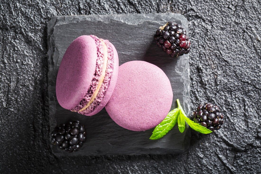 Blackberry macaroons on a black stone