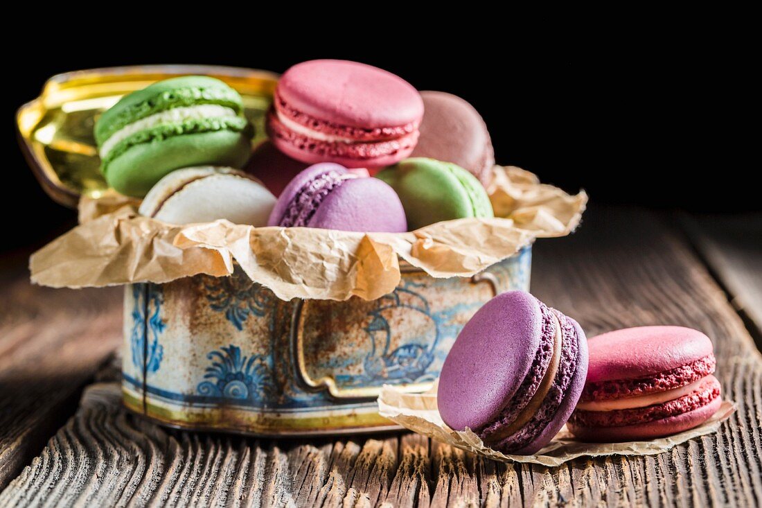 Colourful macaroons in an old metal tin