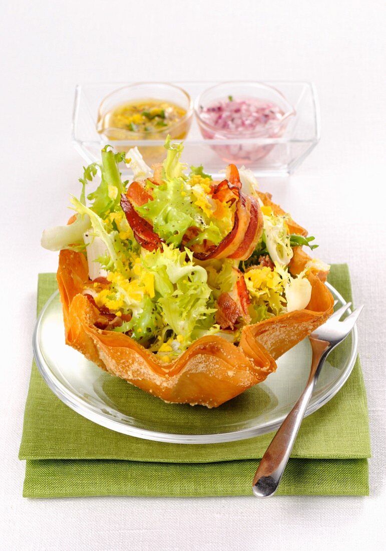 Frisee lettuce with bacon, egg and two salad dressings