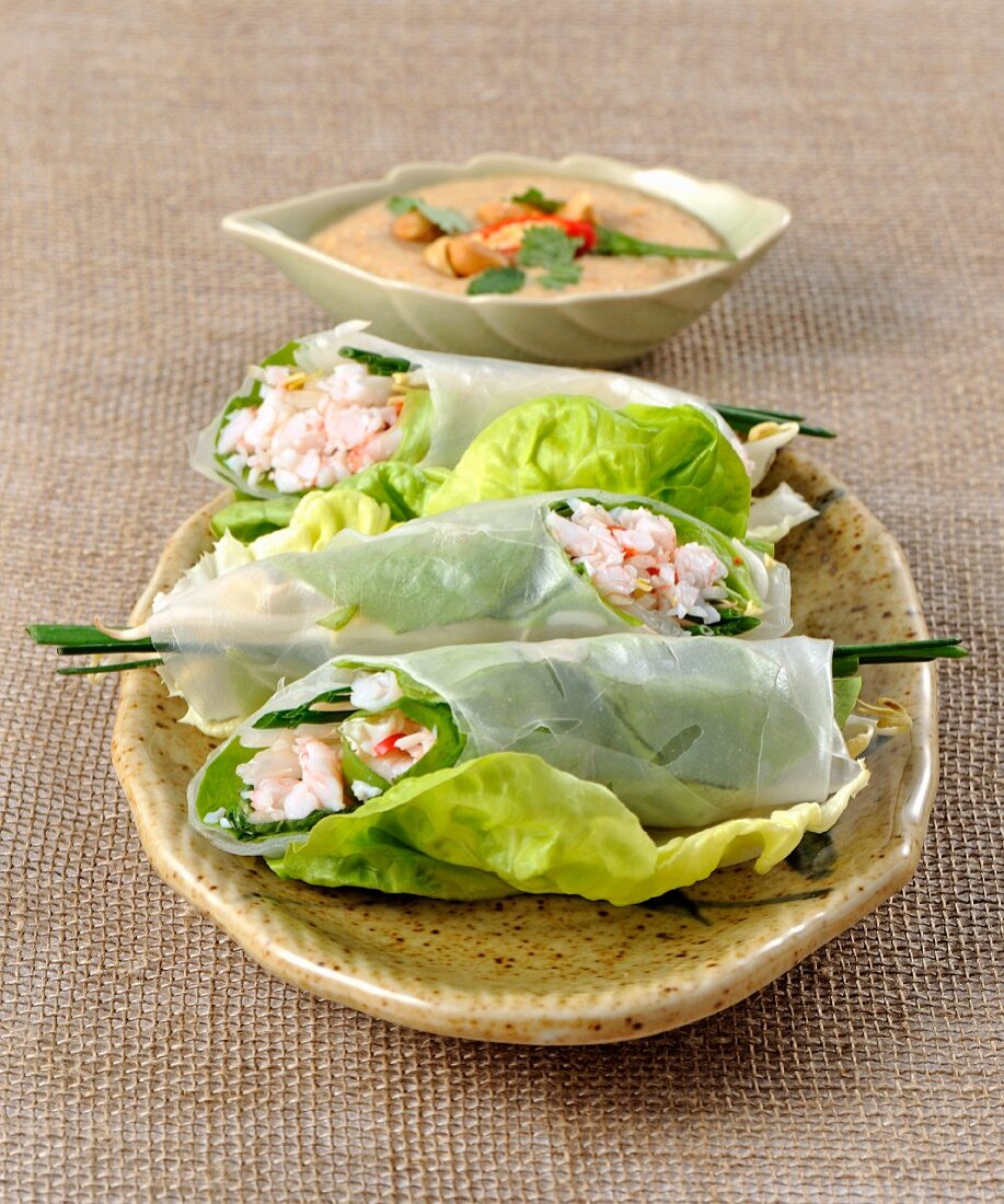 Rice paper rolls filled with prawns on lettuce leaves